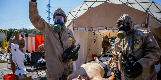 Ukrainian Emergency Ministry rescuers attend an exercise in the city of Zaporizhzhia on Aug. 17, 2022, in case of a possible nuclear incident at the nuclear power plant located near the city.
