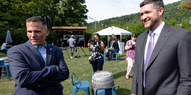 Marc Molinaro and Pat Ryan talk before the start of a candidate forum at the Roscoe Beer Co. in Roscoe, New York, on Thursday, Aug. 18, 2022.