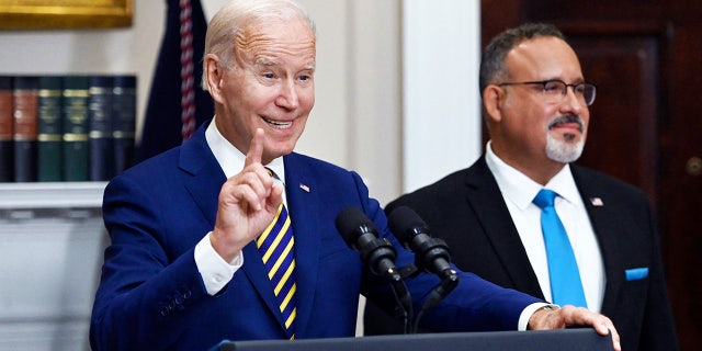 US President Joe Biden announces student loan relief with Education Secretary Miguel Cardona (R) on August 24, 2022 in the Roosevelt Room of the White House in Washington, D.C.