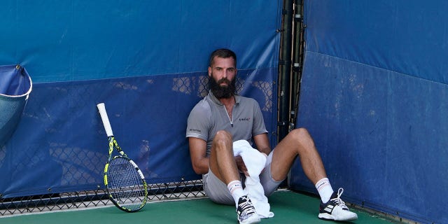 France's Benoit Paire sits on the court during his match against Britain's Cameron Norrie as first responders attend to a medical emergency in the stands at the 2022 U.S. Open at the USTA Billie Jean King National Tennis Center in New York on Aug. 30, 2022.