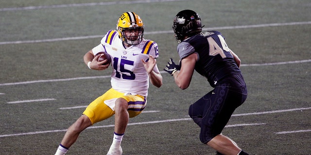 Quarterback Myles Brennan (15) of the LSU Tigers is pursued by Christian James of the Vanderbilt Commodores during the second half at Vanderbilt Stadium on Oct. 3, 2020, in Nashville, Tennessee.