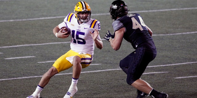 Quarterback Myles Brennan (15) of the LSU Tigers is pursued by Christian James of the Vanderbilt Commodores during the second half at Vanderbilt Stadium on Oct. 3, 2020, in Nashville, Tennessee.