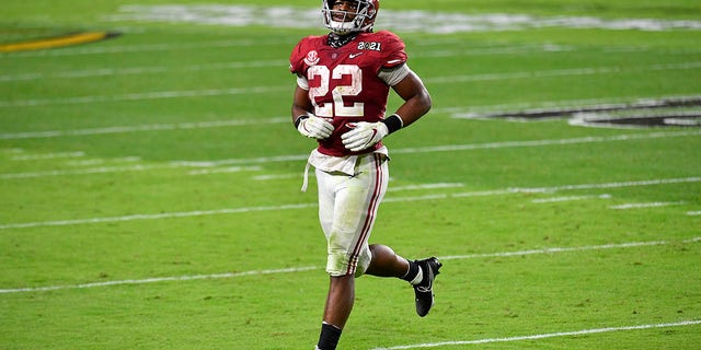 Najee Harris #22 of the Alabama Crimson Tide runs on the field during the College Football Playoff National Championship football game against the Ohio State Buckeyes at Hard Rock Stadium on Jan. 11, 2021 in Miami Gardens, Florida. The Alabama Crimson Tide defeated the Ohio State Buckeyes 52-24. 