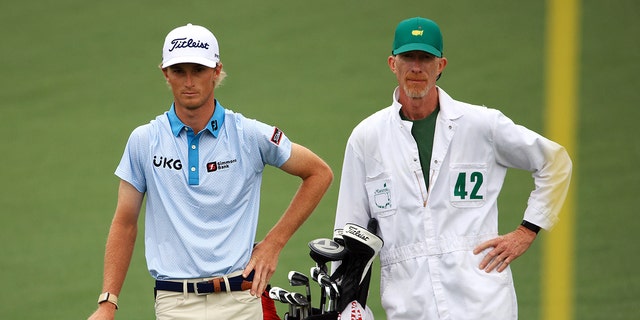 Will Zalatoris talks with his caddy, Ryan Goble, on the second hole during the third round of the Masters at Augusta National Golf Club on April 10, 2021 in Augusta, Georgia.