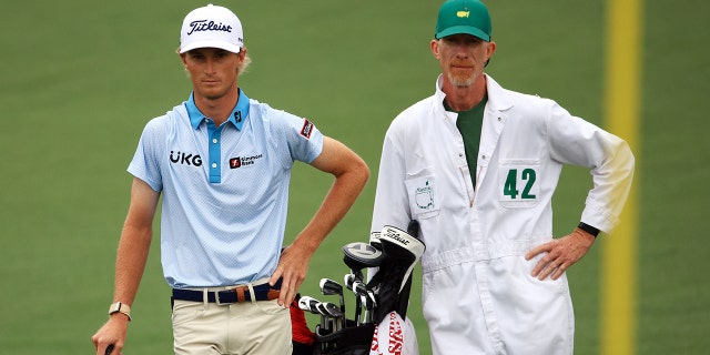 Will Zalatoris talks with his caddy, Ryan Goble, on the second hole during the third round of the Masters at Augusta National Golf Club on April 10, 2021 in Augusta, Georgia.