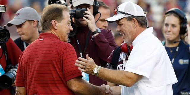 Head coach Nick Saban of the Alabama Crimson Tide and head coach Jimbo Fisher of the Texas A and M Aggies meet before a game at Kyle Field Oct. 9, 2021, in College Station, Texas. 
