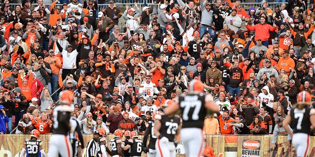 Fans cheer as Baker Mayfield of the Cleveland Browns celebrates a touchdown with teammates at the end of the second quarter against the Arizona Cardinals at FirstEnergy Stadium in Cleveland, Ohio, on Oct. 17, 2021.