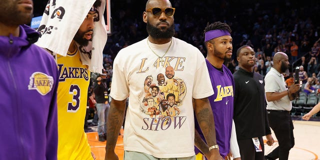 LeBron James, #6, and Anthony Davis, #3 of the Los Angeles Lakers, walk off the court following the NBA game at Footprint Center on April 05, 2022 in Phoenix. The Suns defeated the Lakers 121-110.