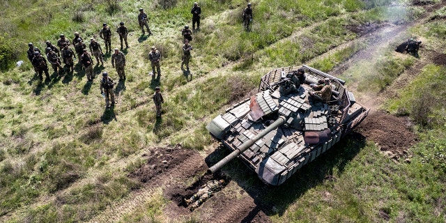 A Ukrainian tank drives over an infantryman during a training exercise near Dnipropetrovsk Oblast, Ukraine, on May 9, 2022.