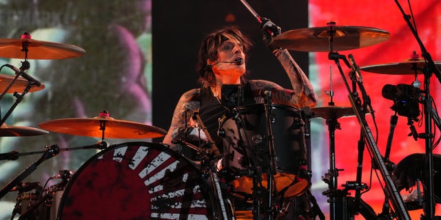 Tommy Lee performs in Washington, D.C., during a Mötley Crüe concert. He recently explained to fans during a concert stop in Texas that his nude photo was due to a bender he went on during a break in the tour schedule.