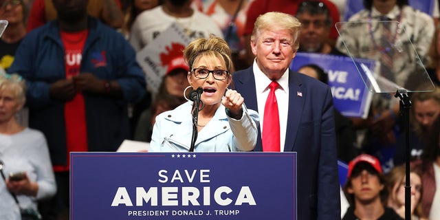 Former Alaska Gov.  Sarah Palin speaks as former US President Donald Trump looks on during a "save america" rally at Alaska Airlines Center on July 09, 2022 in Anchorage, Alaska.