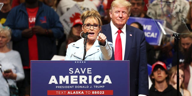 Former Alaska Gov. Sarah Palin speaks as former President Donald Trump looks on during a "Save America" rally on July 9, 2022, in Anchorage, Alaska.