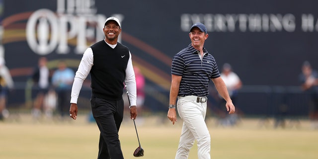 Tiger Woods, of The United States, and Rory McIlroy, of Northern Ireland, on the 18th fairway  during the Celebration of Champions prior to The 150th Open at St Andrews Old Course on July 11, 2022 in St Andrews, Scotland. 