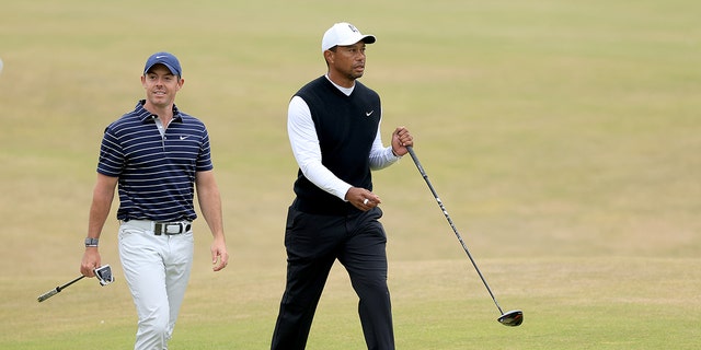 Tiger Woods, of The United States, with Rory McIlroy, of Northern Ireland, during the Celebration of Champions prior to The 150th Open at St Andrews Old Course on July 11, 2022 in St Andrews, Scotland. 