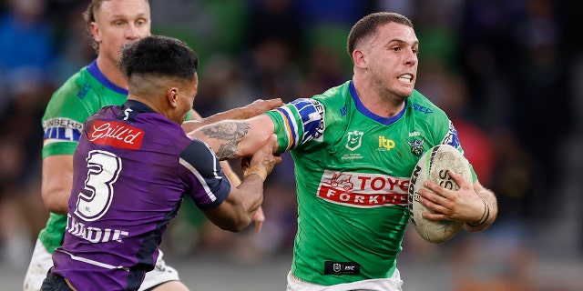 Adam Elliott of the Canberra Raiders stiff-arms Marion Seve during a round 18 NRL match against the Melbourne Storm at AAMI Park July 17, 2022, in Melbourne, Australia.