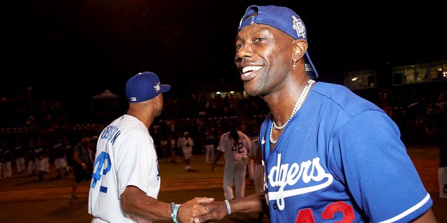 Terrell Owens celebrates the end of a game on the field at the Bumpboxx Honors 75th Anniversary Of Jackie Robinson Breaking The Color Barrier With Celebrity Softball Game At Jackie Robinson Field at Jackie Robinson Stadium on July 17, 2022 in Los Angeles.