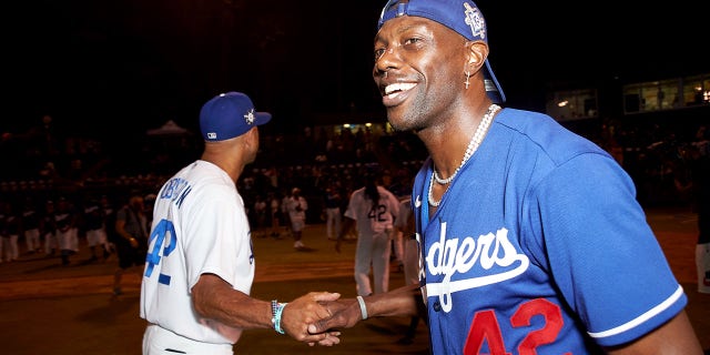 Terrell Owens celebrates the end of a game on the field at the Bumpboxx Honors 75th Anniversary Of Jackie Robinson Breaking The Color Barrier With Celebrity Softball Game At Jackie Robinson Field at Jackie Robinson Stadium on July 17, 2022 in Los Angeles.
