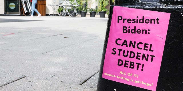 A sign asking President Biden to cancel student debt.