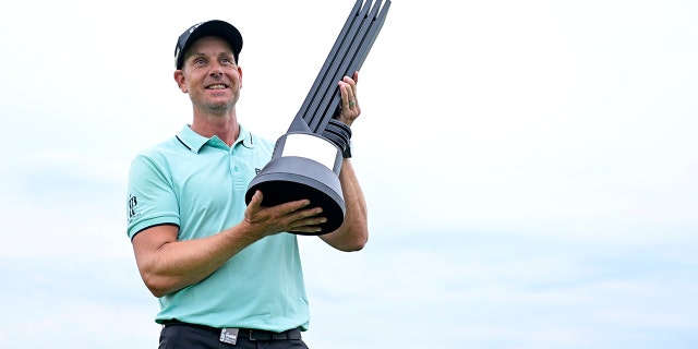 Henrik Stenson of Majesticks GC poses with the first place trophy after winning the LIV Golf Invitational Bedminster at Trump National Golf Club in Bedminster, NJ, July 31, 2022 .