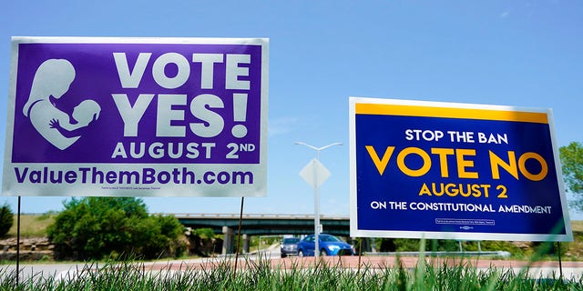 On August 1, 2022, signs for and against the Kansas Amendment to the Abortion will be displayed outside the Kansas 10 Highway in Lenexa, Kansas.