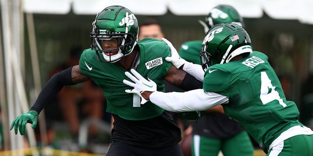 Cornerbacks Sauce Gardner, left, and D.J. Reed of the New York Jets block each other during training camp at Atlantic Health Jets Training Center in Florham Park, New Jersey, on Aug. 1, 2022.