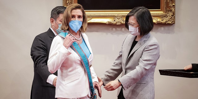 Speaker of the U.S. House Of Representatives Nancy Pelosi (D-CA), center, receives the Order of Propitious Clouds with Special Grand Cordon, Taiwan’s highest civilian honour, from Taiwan's President Tsai Ing-wen, right, at the president's office on August 03, 2022 in Taipei, Taiwan.