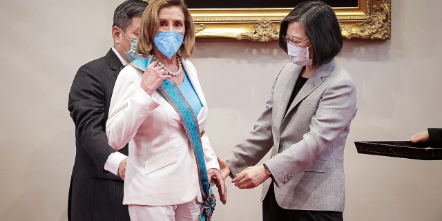 Nancy Pelosi, D-CA, center, receives the Order of Propitious Clouds with Special Grand Cordon from Taiwan's President Tsai Ing-wen, right, at the president's office on August 03, 2022 in Taipei, Taiwan.