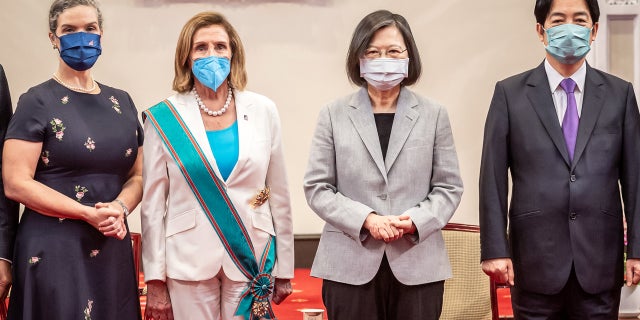 Speaker of the House of Representatives Nancy Pelosi (D-CA), left center, poses for photographs after receiving the Order of Propitious Clouds with Special Grand Cordon, Taiwan's highest civilian award, from Taiwan President Tsai Ing-wen, center right, at the president's office.