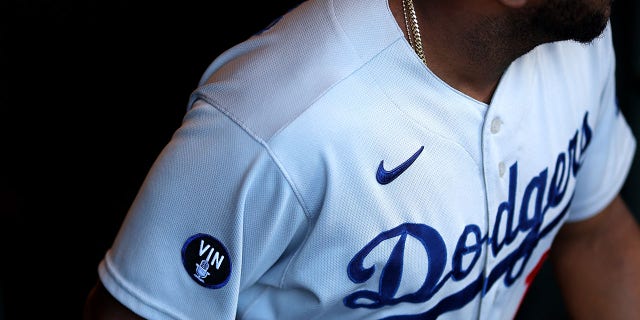 Hanser Alberto of the Los Angeles Dodgers wears a patch to honor Vin Scully, who passed away Tuesday, during the Giants game at Oracle Park on Aug. 3, 2022, in San Francisco.