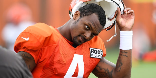 Deshaun Watson, #4 of the Cleveland Browns, takes off his helmet during Cleveland Browns training camp at CrossCountry Mortgage Campus on August 09, 2022 in Berea, Ohio. 