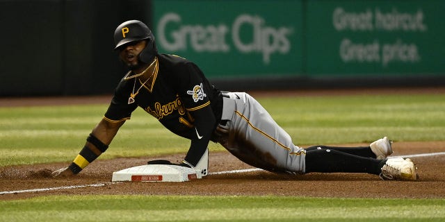 Rodolfo Castro #14 of the Pittsburgh Pirates slides into third base as his cell phone falls out of his pocket during the fourth inning of a game against the Arizona Diamondbacks at Chase Field on August 09, 2022 in Phoenix, Arizona.