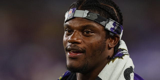 Baltimore Ravens' Lamar Jackson looks on from the sidelines during the second half against the Tennessee Titans at M and T Bank Stadium on August 11, 2022 in Baltimore, Maryland.