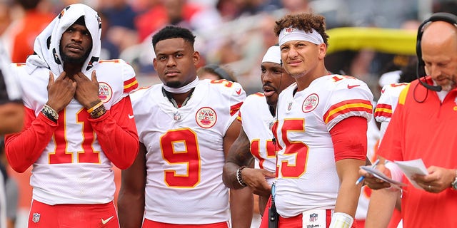 Marquez Valdes-Scantling #11, JuJu Smith-Schuster #9, and Patrick Mahomes #15 look on against the Chicago Bears during the first half of the preseason game at Soldier Field on August 13, 2022 in Chicago, Illinois. 