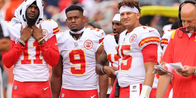 Marquez Valdes-Scantling #11, JuJu Smith-Schuster #9, and Patrick Mahomes #15 look on against the Chicago Bears during the first half of the preseason game at Soldier Field on August 13, 2022 in Chicago, Illinois. 