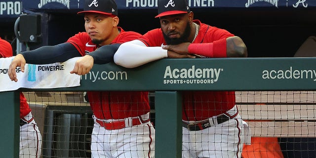 Marcell Ozuna #20 and William Contreras #24 of the Atlanta Braves look on from the dugout during the first inning against the Houston Astros at Truist Park on August 19, 2022 in Atlanta, Georgia. 