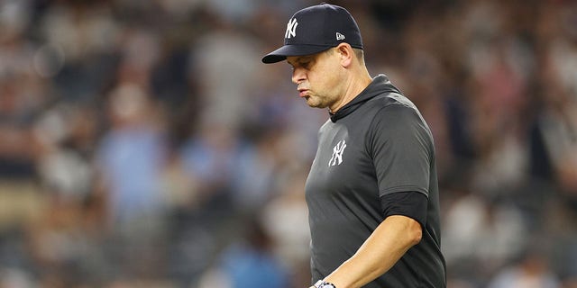 Manager Aaron Boone #17 of the New York Yankees walks to the dugout after taking Jameson Taillon #50 (not pictured) off the mound during the sixth inning against the Toronto Blue Jays at Yankee Stadium on August 19, 2022 in the Bronx borough of New York City. 