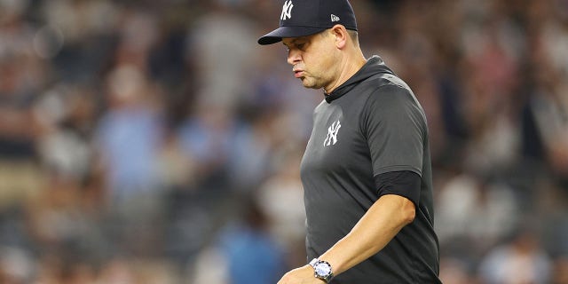 Aaron Boone #50 of the New York Yankees after taking Jameson Tyrone #50 (not pictured) off the mound in the sixth inning against the Toronto Blue Jays at Yankee Stadium in the Bronx Borough of the New York Yankees on August 19, 2022. 17 The manager is walking into the dugout. York city. 