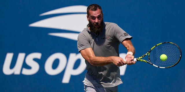 Benoit Paire of France plays a backhand against Cameron Norrie of Great Britain during the first round of men's singles at the 2022 US Open at the USTA Billie Jean King National Tennis Center on August 30, 2022 in New York City. 
