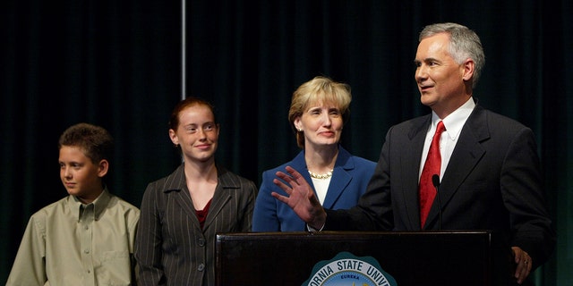 Republican gubernatorial candidate Tom McClintock speaks to reporters with his wife Lori, daughter Shannah and son Justin after participating in a debate at California State University, Sacramento, on Sept.  24, 2003. 