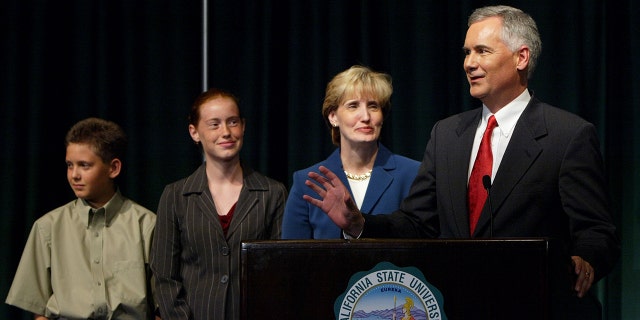 Tom McClintock speaks to reporters with wife