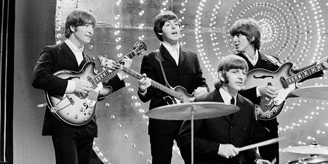 The Beatles perform "Rain" and "Paperback Writer" on the BBC TV show "Top of the Pops" in London on June 16, 1966. 