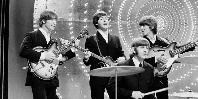 The Beatles perform "Rain" and "Paperback Writer" on the BBC TV show "Top of the Pops" in London on June 16, 1966. 