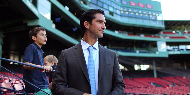 Mike Hazen, former senior vice president/general manager of the Red Sox and his son Charlie (left) look over Fenway Park.