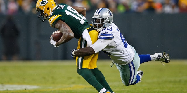 Randall Cobb of the Green Bay Packers, left, is tackled by Rolando McClain of the Dallas Cowboys at Lambeau Field, Dec. 13, 2015, in Green Bay, Wisconsin.