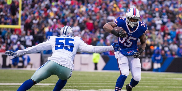 Mike Gillislee (35) of the Buffalo Bills breaks a tackle by Rolando McClain (55) of the Dallas Cowboys, Dec. 27, 2015, at Ralph Wilson Stadium in Orchard Park, New York.