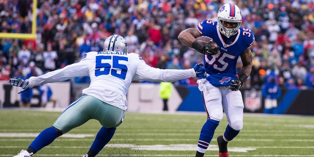 Mike Gillislee (35) of the Buffalo Bills breaks a tackle by Rolando McClain (55) of the Dallas Cowboys, Dec. 27, 2015, at Ralph Wilson Stadium in Orchard Park, New York.