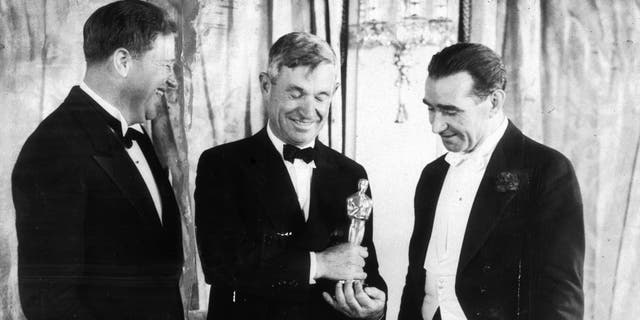 American sound engineer Franklin Hansen, actor and writer Will Rogers (center) and Scottish-born director Frank Lloyd stand at the podium at the Academy Awards ceremony in Los Angeles, California. Both Hansen and Lloyd won Oscars that year, on March 16, 1934.