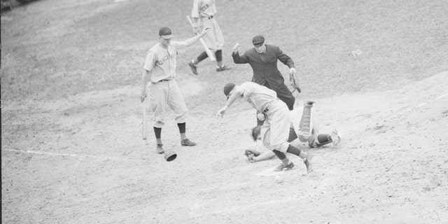 The first televised baseball game, August 26, 1939. Bucky Walters of the Cincinnati Reds pitched a two-hit game against the Brooklyn Dodgers and helped himself along by scoring one of the Reds' run in the big eighth inning. The Reds scored all of their runs in the eighth inning to beat the Dodgers, 5-2. Walters is shown scoring here, as Dodgers' catcher Babe Phelps rolls in the dirt after dropping the ball.