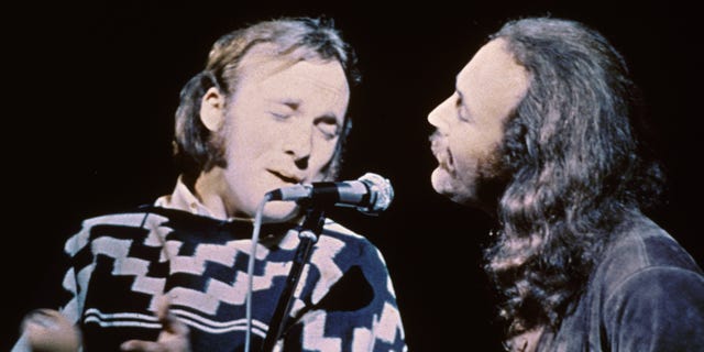 Stephen Stills (left) and David Crosby of the group Crosby, Stills &amp; Nash performing on stage at the Woodstock Music and Art Festival in 1969.