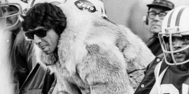Joe Namath of the New York Jets wears his fur coat during a game against the New England Patriots on November 11, 1973 at Shea Stadium in New York.
